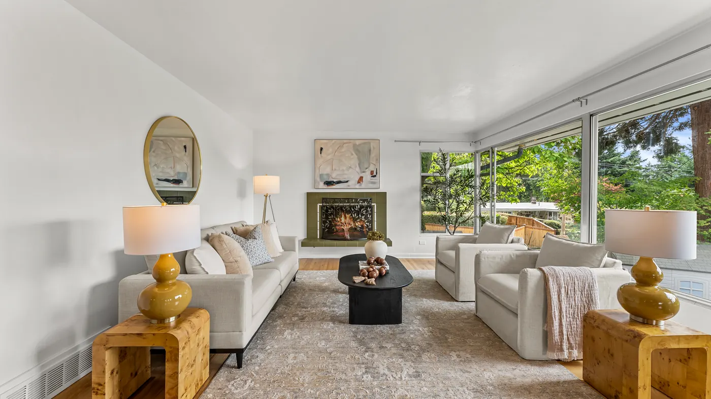 Living room with wide windows onto trees