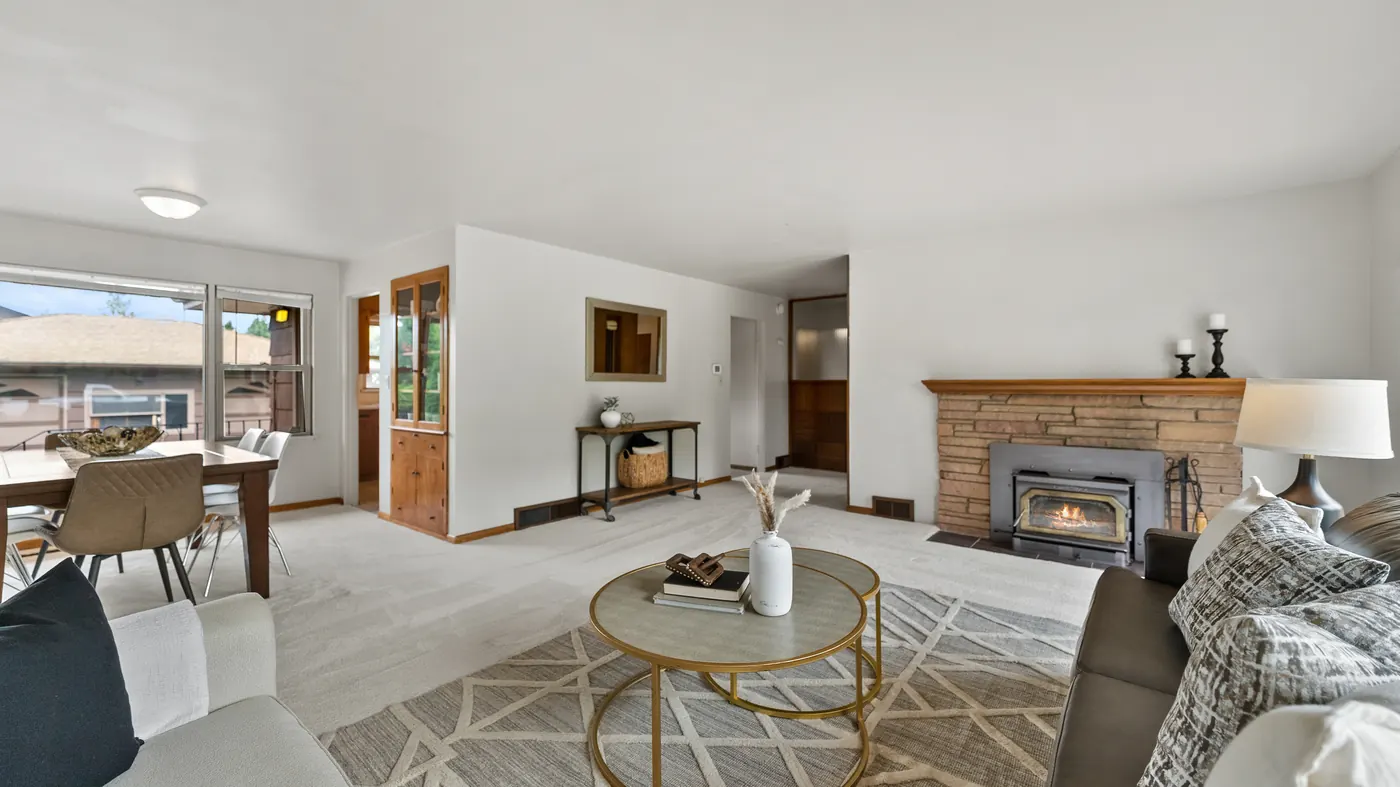 Staged living room with a brick fireplace in a northwest Seattle rambler