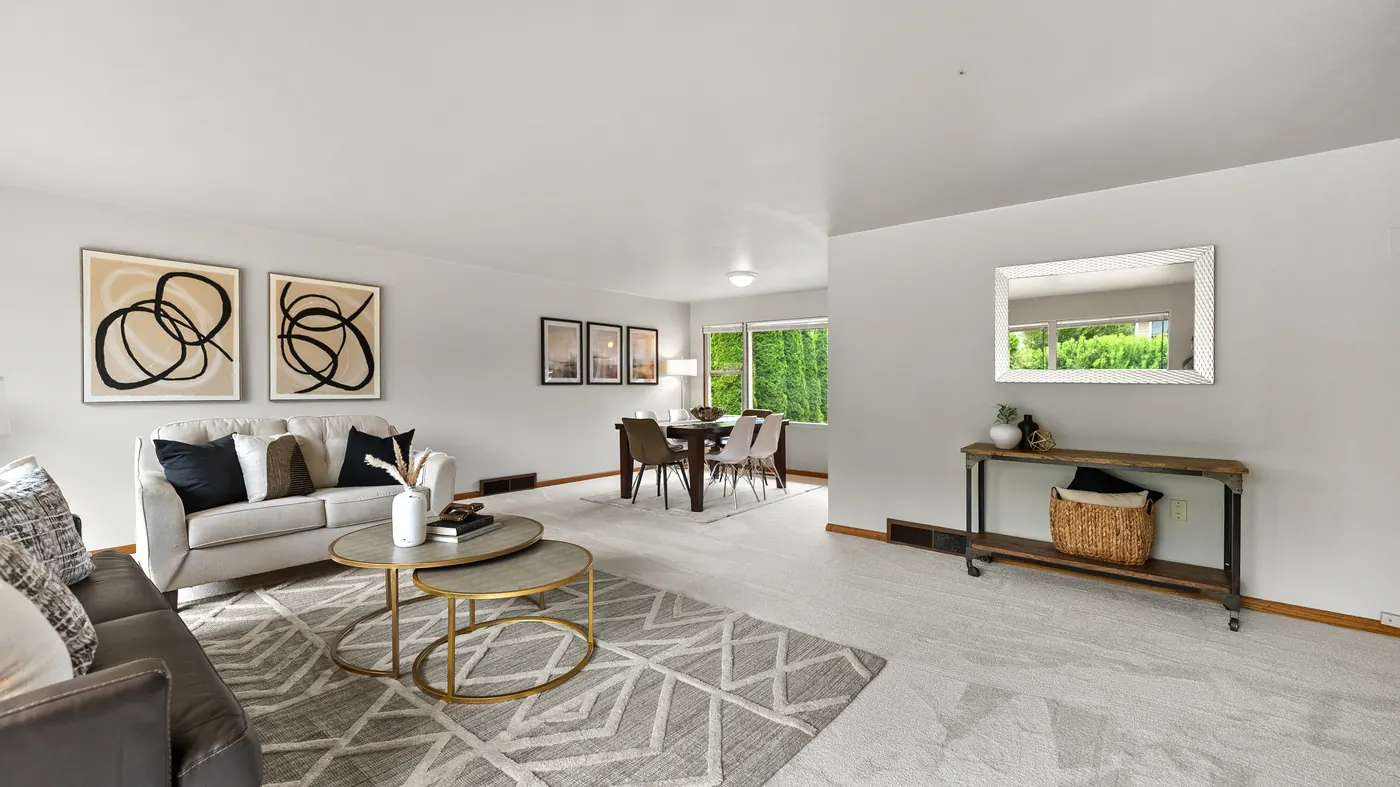 Staged living room with a large front window in a Seattle rambler